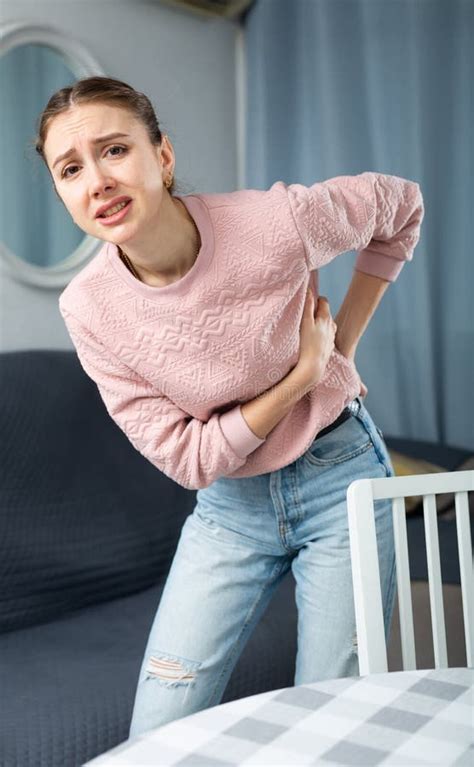 Woman Suffering From Lower Back Pain At Home Stock Photo Image Of