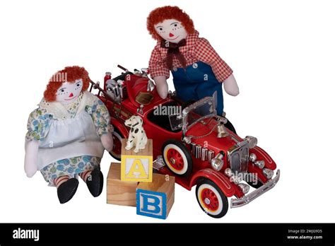 Handmade Rag Dolls Raggedy Ann And Andy Placed Among Toys Blocks Fire