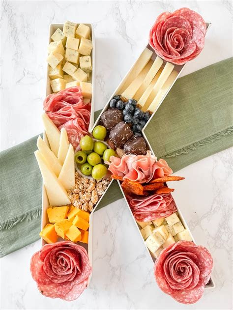 An Assortment Of Cheeses Meats And Vegetables Arranged In The Shape Of