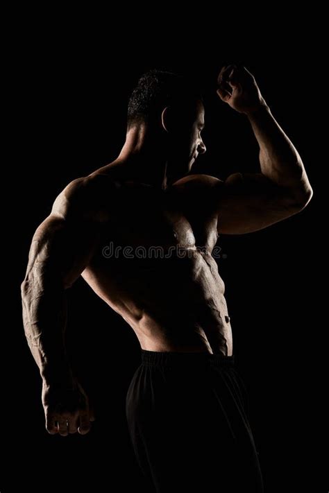 Torso Of Attractive Male Body Builder On Black Background Stock Photo