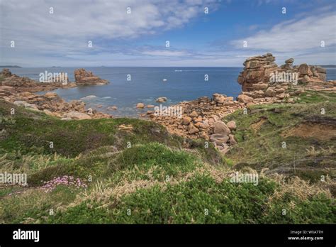 Overview Of Craggy Rock Formations Framing A Sunny Cove Along Brittany