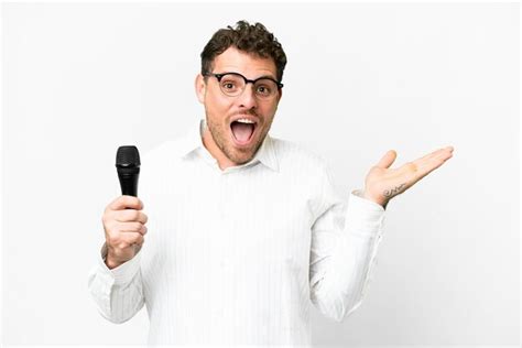 Premium Photo Brazilian Man Picking Up A Microphone Over Isolated