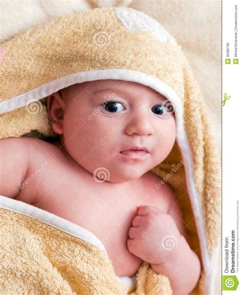 Lovely Months Baby Lying On Bed Covered With Soft Blanket Stock