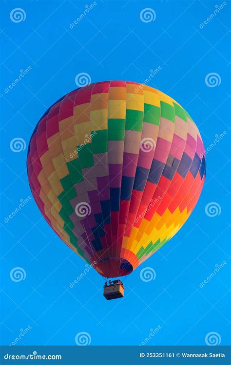 Colorful Hot Air Balloon Flying In The Bright Blue Sky Stock Image