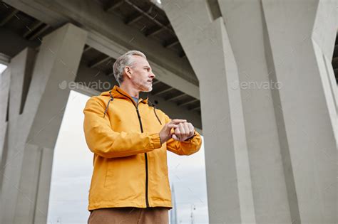 Handsome Mature Man Checking Pulse Stock Photo By Seventyfourimages