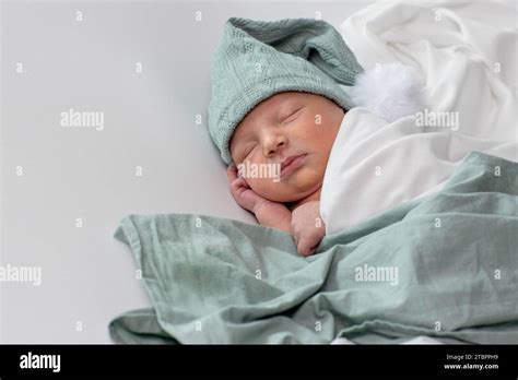 Close Up Of Cute Newborn Baby Sleeping On White Background Covered Care