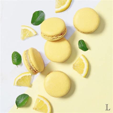 Macaroons And Lemon Slices Are Arranged On A Yellow Background With