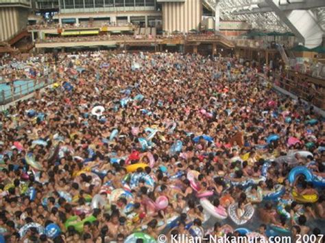 A Large Group Of People Are In The Water At An Indoor Swimming Pool