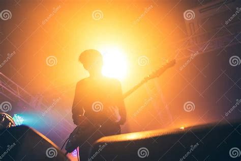 Rock Band Performs On Stage Guitarist Plays Solo Silhouette Of Guitar Player In Action On