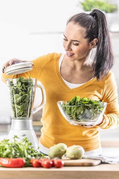 Premium Photo Good Looking Woman Preparing Spinach Smoothie With Blender