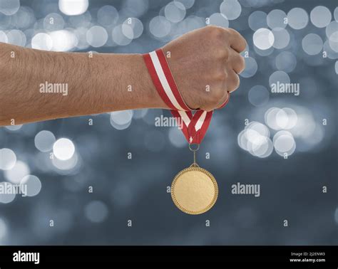 Man Raising Hand And Holding Gold Medal Concept Of Ambition