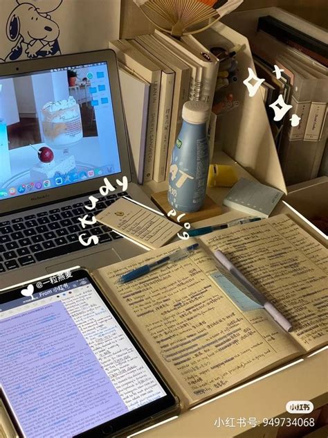 An Open Laptop Computer Sitting On Top Of A Wooden Desk Next To Books