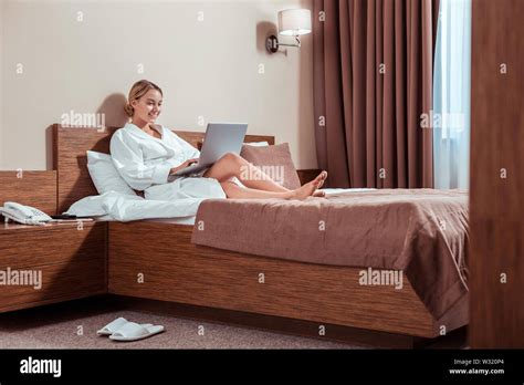 Chilling Blonde Lady Lying On A Bed With Laptop Stock Photo Alamy