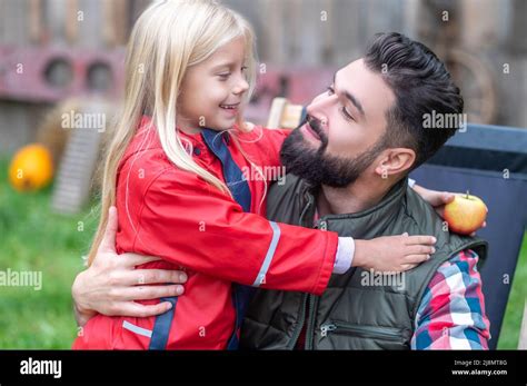 A Cute Blonde Girl Hugging Her Dad And Both Looking Happy Stock Photo Alamy