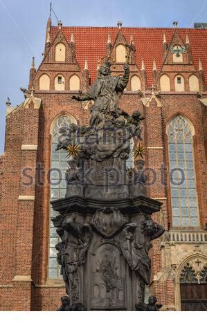 Statue Of St John Nepomuk And Collegiate Church Of The Holy Cross At