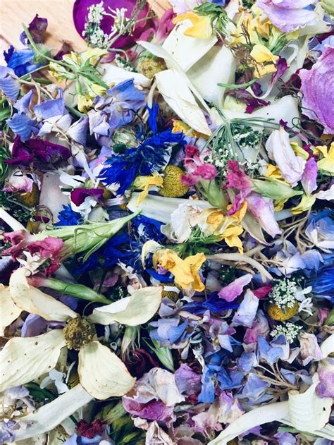 A Pile Of Dried Flowers Sitting On Top Of A Wooden Table