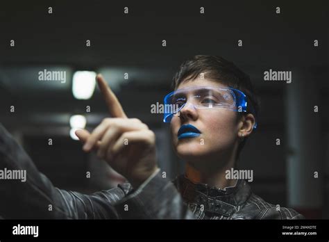 Woman wearing smart glasses gesturing at parking garage Stock Photo - Alamy