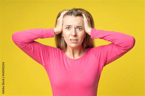 Shocked Anxious Young Woman Dressed In Red In Silent Panic Holding Hands On Head Worrying