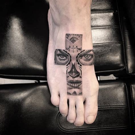 Calavera Catrina cross tattoo on the right foot.