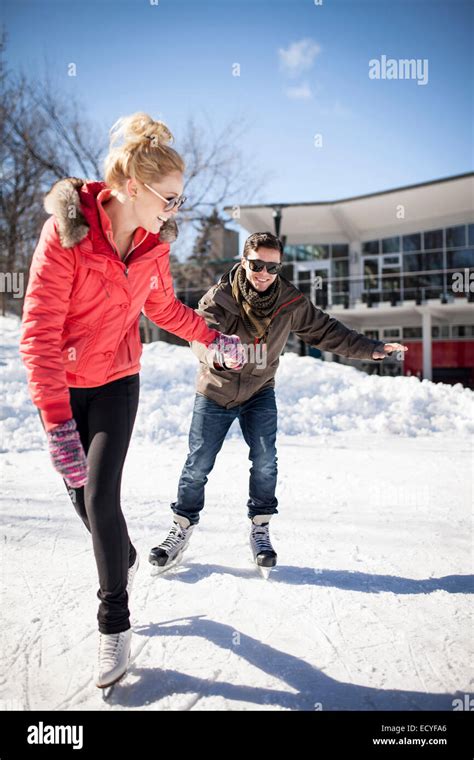 Caucasian Couple Ice Skating On Frozen Lake Stock Photo Alamy