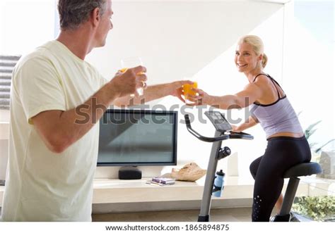 Wife Passing A Bottle To Husband Over 15 Royalty Free Licensable Stock