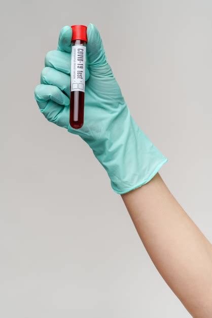 Premium Photo Hand In Latex Glove Holding Blood In Test Tube