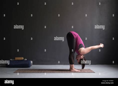 Sporty Woman Practicing Yoga Standing Forward Bend Exercise