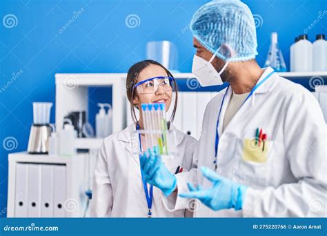 Man And Woman Scientists Holding Test Tubes At Laboratory Stock Photo