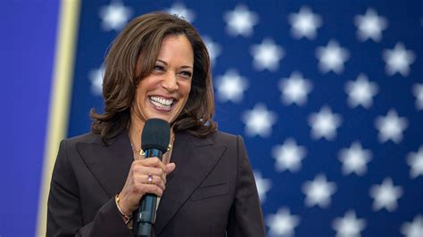vice president kamala harris  holding mic  smiling  shallow
