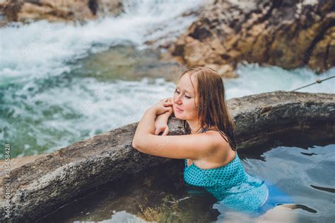 Geothermal Spa Woman Relaxing In Hot Spring Pool Against The Background Of A Waterfall Stock