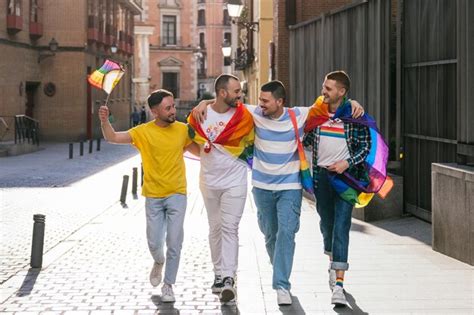Premium Photo Radiant Sunset Stroll Four Gay Friends Embrace Adorned With Vibrant Lgbt Pride