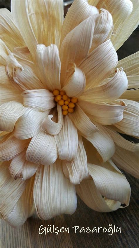 A Large White Flower Sitting On Top Of A Wooden Table