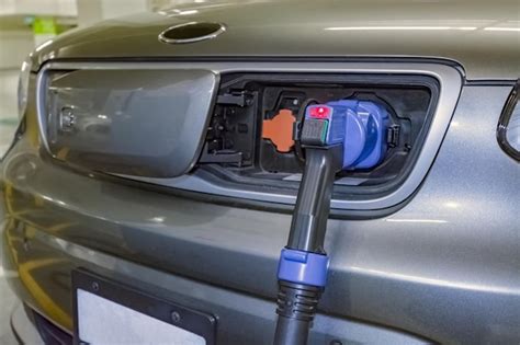 Premium Photo Electric Plug Connected To A Vehicle For Battery Energy