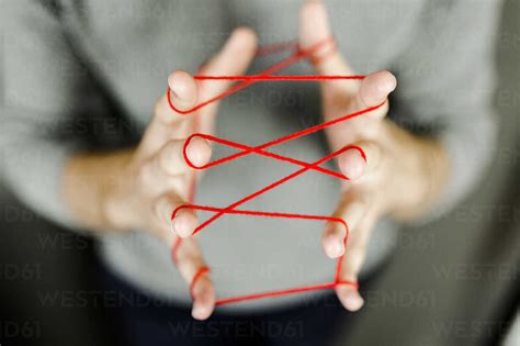 Close Up Of Man Holding String Stock Photo