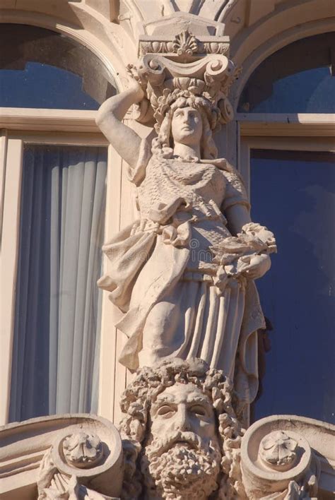 Caryatid Sculpture Adorns The Facade Of The Old House On The Street Of