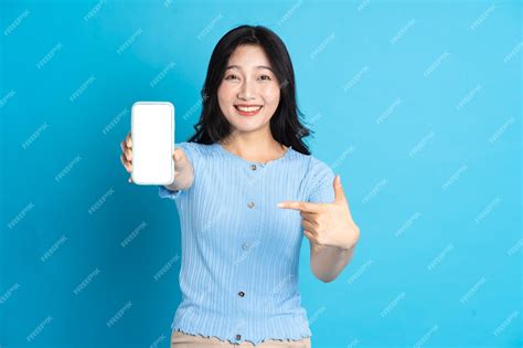 Premium Photo Portrait Of Smiling Asian Woman Posing On Blue Background