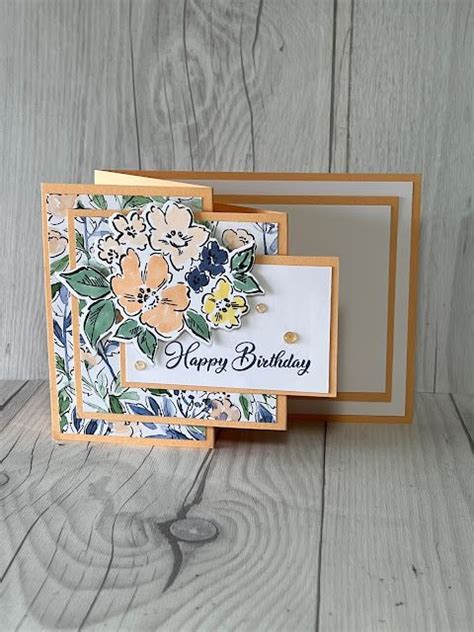 A Close Up Of A Card With Flowers On It And A Happy Birthday Sign In