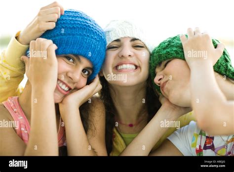 Three Young Female Friends Wearing Knit Hats Smiling Stock Photo Alamy