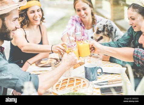 Happy Millennial Friends Cheering At Breakfast Brunch Meal In Nature