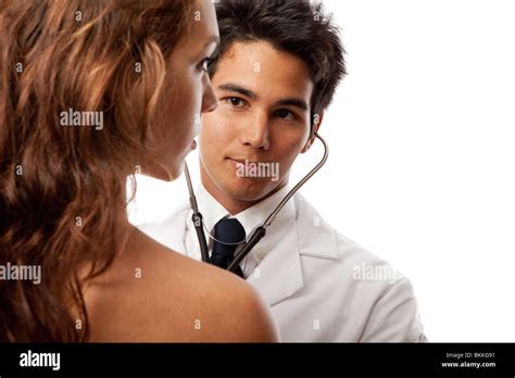 Young Asian Doctor Listening To The Heartbeat Of A Female Patient With