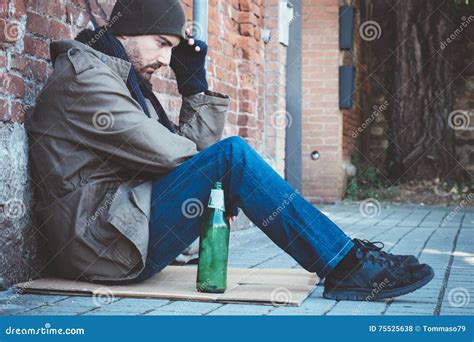 Homeless Man Drinking Alcohol From A Bottle Stock Photo Cartoondealer