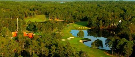 An Aerial View Of A Golf Course Surrounded By Trees