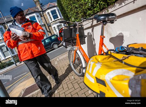 Royal mail postman in traditional uniform hi-res stock photography and ...