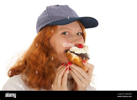 Female Baker Chef With Red Hair Eating Pastry Isolated Over White