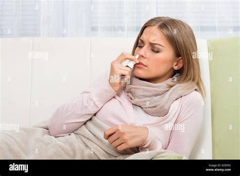 Woman Using Nasal Spray Stock Photo Alamy