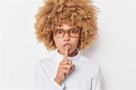 Free Photo Portrait Of Surprised Curly Haired Young Woman Makes