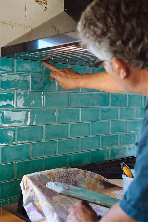 Tiler Grouting Kitchen Tiles By Stocksy Contributor Rowena Naylor