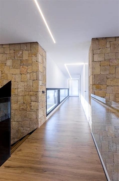 An Empty Hallway With Stone Walls And Wooden Floors