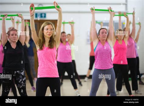 Women participating in POUND fitness class, hour long workout drumming ...