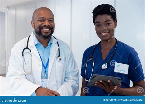 Portrait Of Smiling African American Male And Female Doctor In Hospital